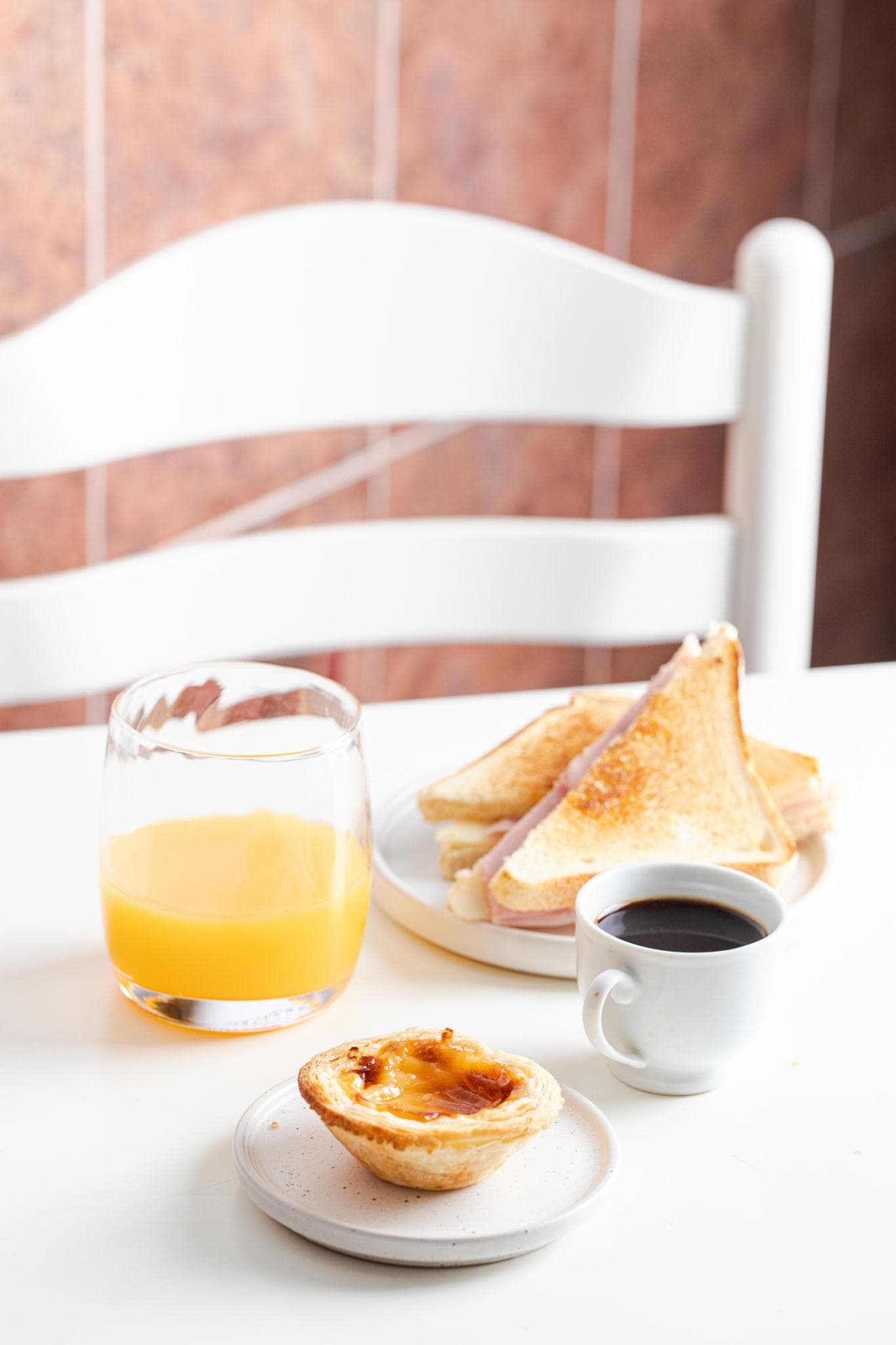 Breakfast at a Portuguese pastelaria with coffee, bread and pastries